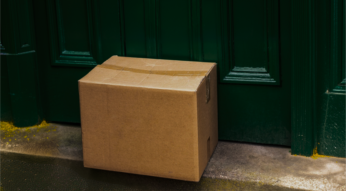 A plain cardboard parcel left at a front door